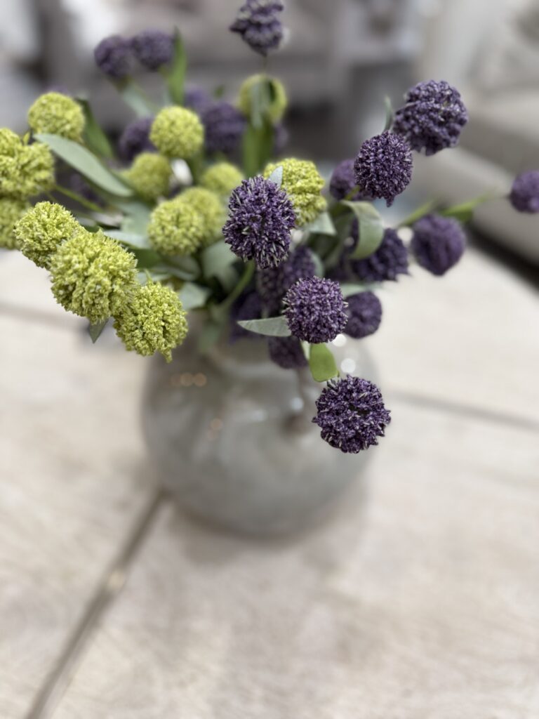 Fresh spring floral arrangement with alliums on coffee table The Woodlands interior design