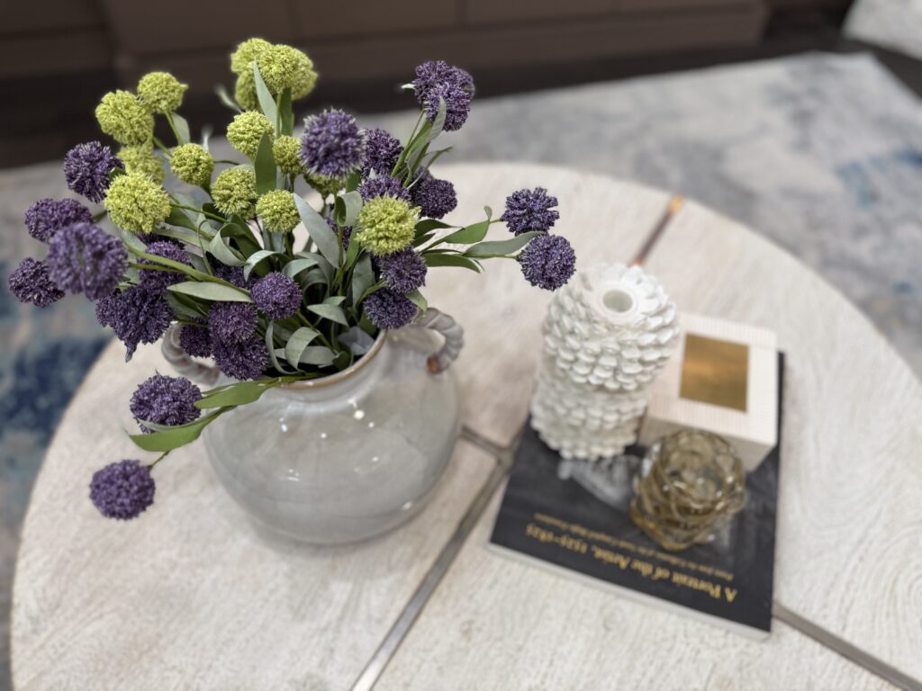 Spring coffee table styling with fresh flowers and pastel accents Houston interior designer