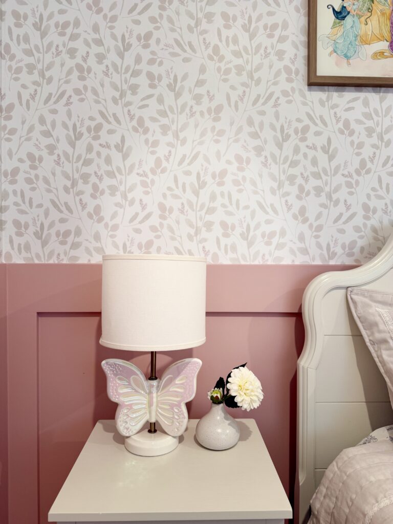 White nightstand with butterfly lamp and floral details designed by Emmas Interior in Magnolia TX