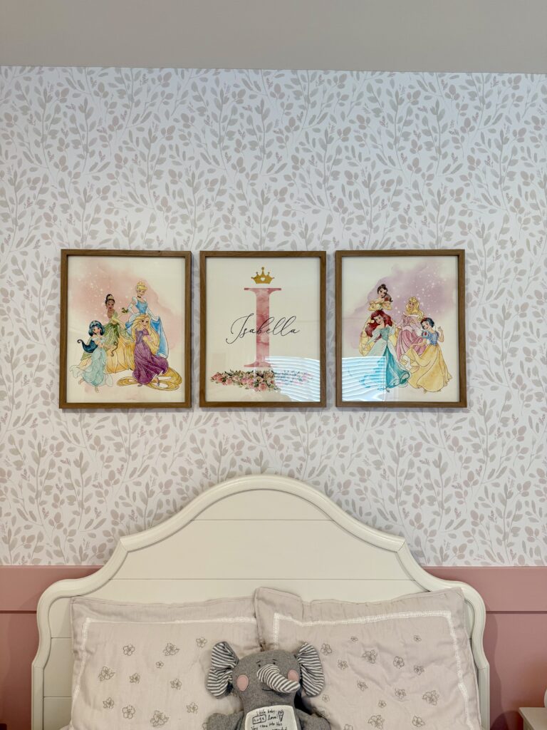Elegant gold framed princess castle art prints styled over a white scalloped bed in Cypress Texas